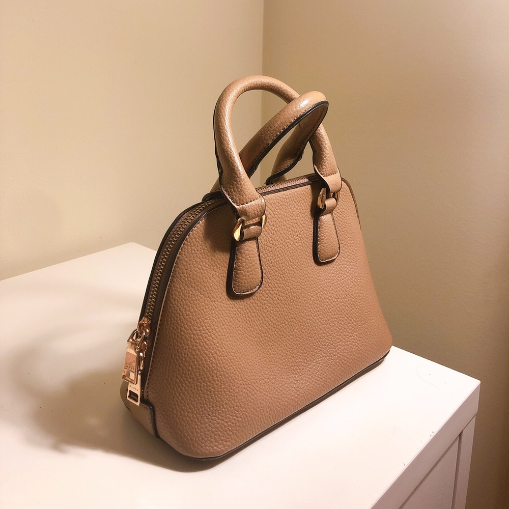 Small beige color bag, and it comes with a strap.